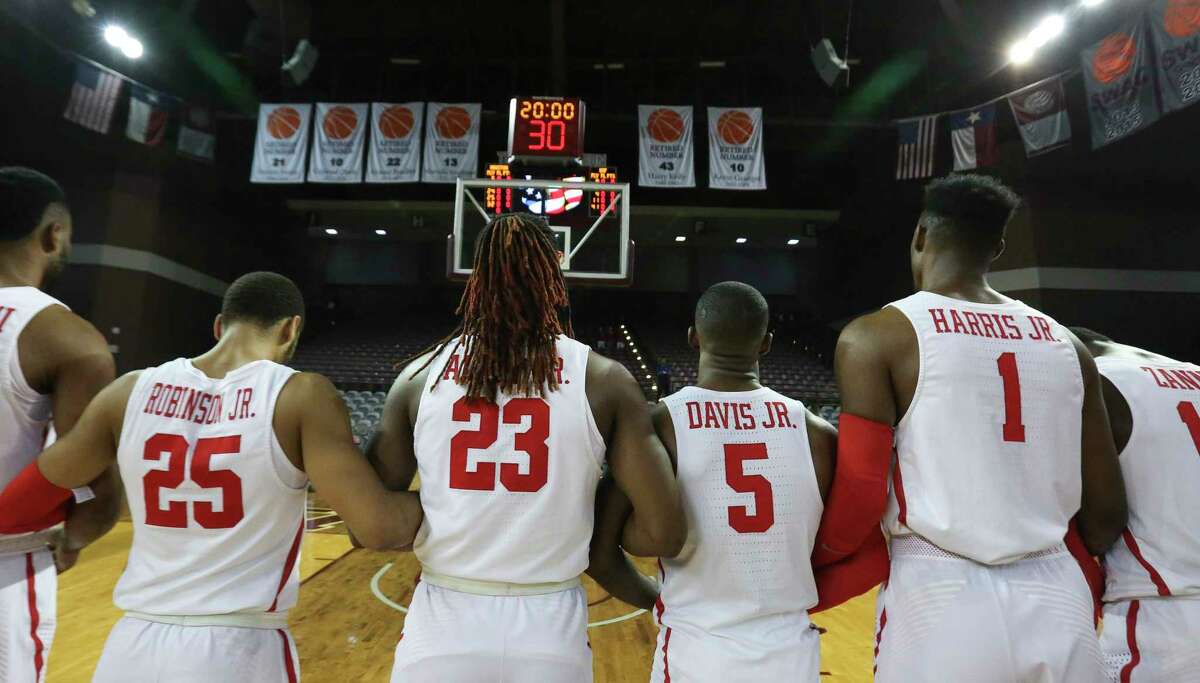 Houston Cougars players Galen Robinson Jr. (25), Cedrick Alley Jr (23), Corey Davis Jr. (5) and Chris Harris Jr. (1) lock their arms during National Anthem before the American Athletic Conference game against the South Florida Bulls at H&PE Arena on Sunday, Jan. 28, 2018, in Houston.