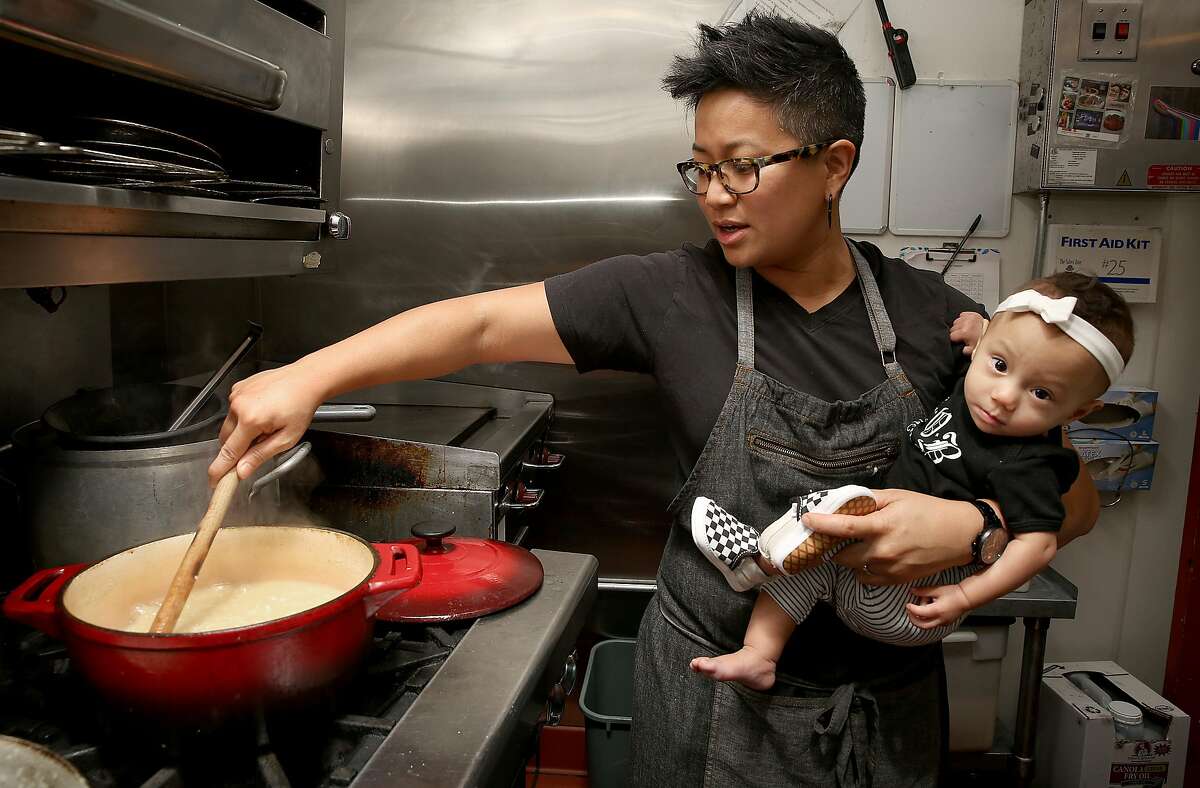 Janice Dulce, a chef at Gashead Tavern who does Filipino pop up dinners makes arroz caldo (chicken rice porridge) with her daughter Phoenix Dulce, 9 mos., on Monday, November 13, 2017, in San Francisco, Calif.
