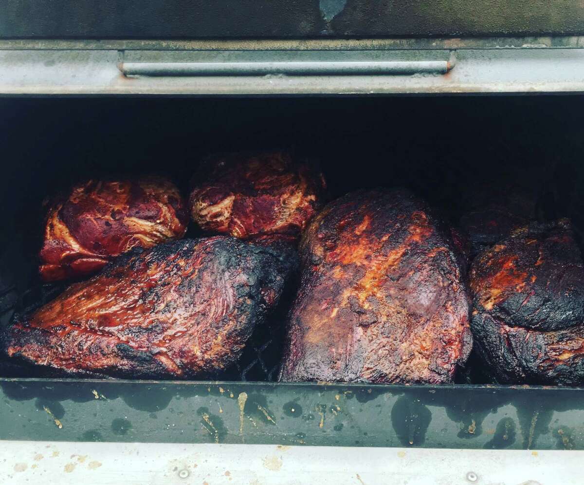 Briskets and pork butts fill the smoker of the Shugga Barrz Bee-Bee Q pits. The San Antonio team is comprised of a large group of friends and led by cook Eddie Meza.