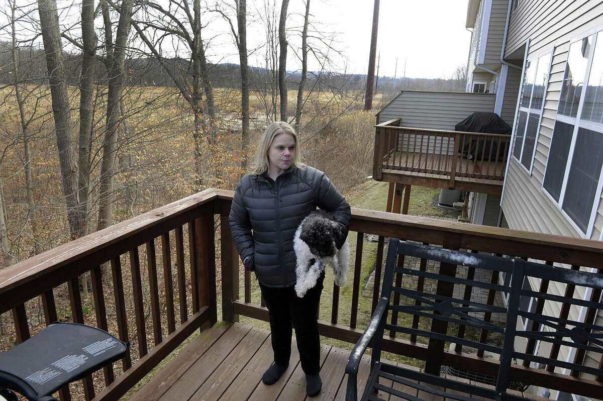 Melissa Rinaldi, a resident of Lexington Meadows Condominiums in Bethel, talks about Eversource’s plans to install a poll near to her home, in the marshland behind her, Monday, January 29, 2018.