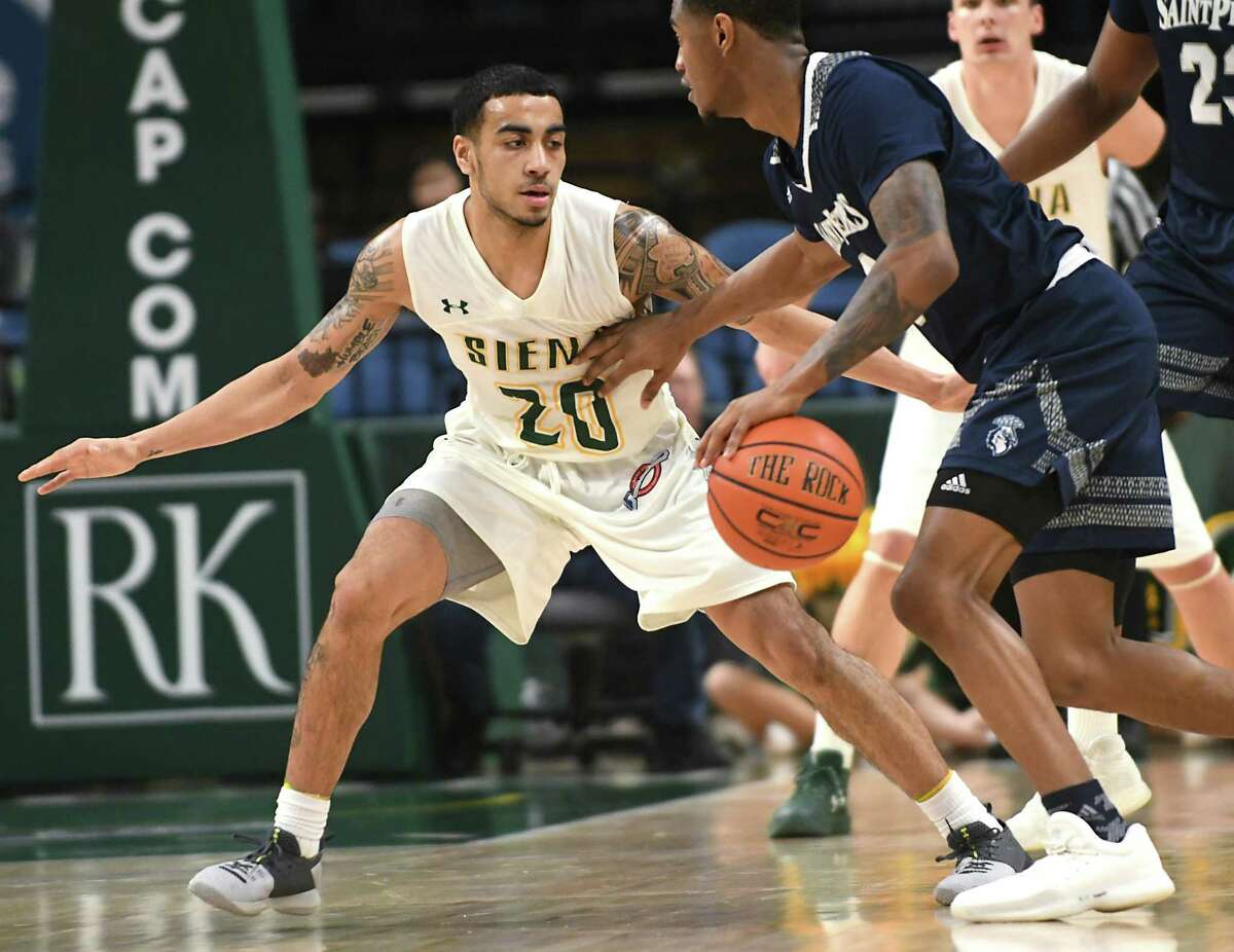 Siena's Roman Penn guards by Saint Peter's Nick Griffin during a basketball game at the Times Union Center on Monday, Jan. 29, 2018 in Albany, N.Y. (Lori Van Buren/Times Union)