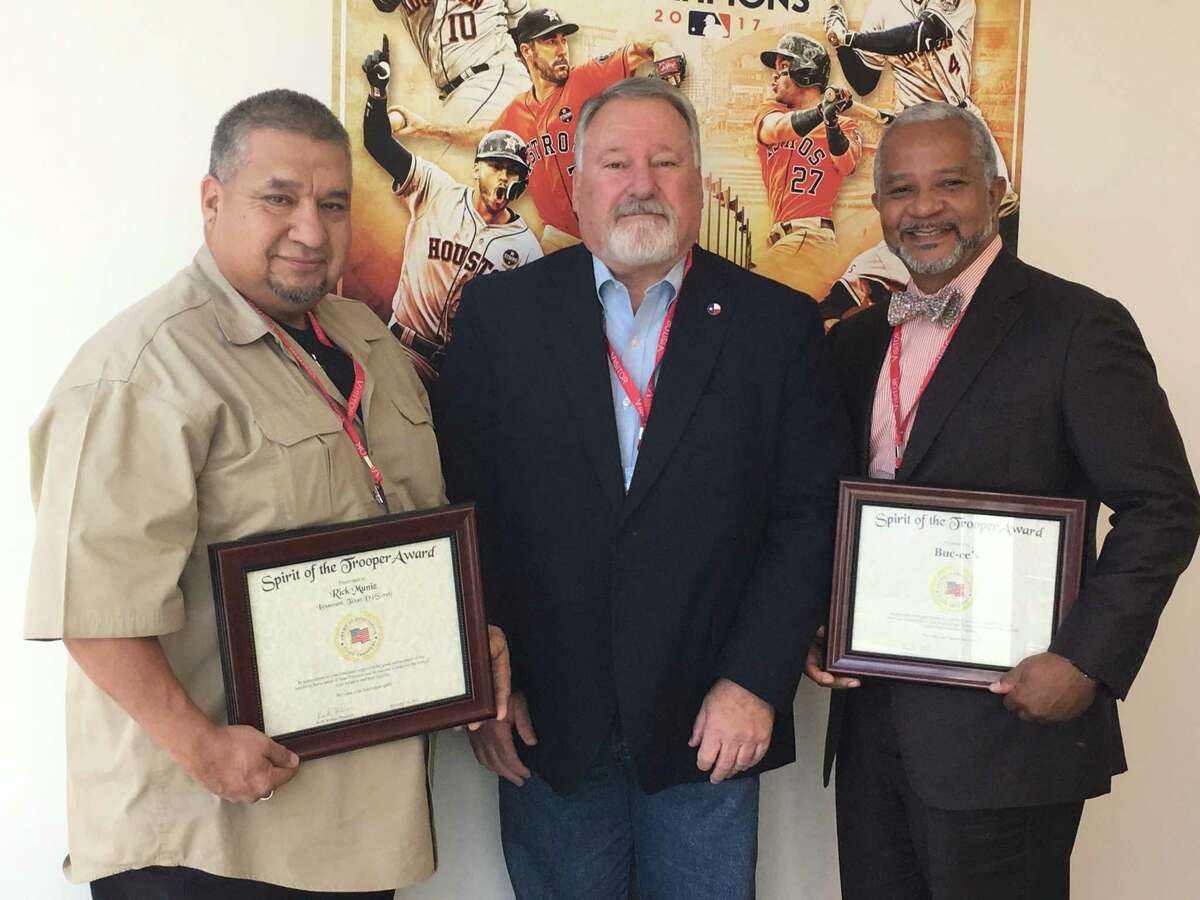 Rick Muniz, a retired DPS lieutenant, enlisted the help of friends, including George Rhyne, retired DPS major, to cook and serve thousands of meals to first responders, volunteers and evacuees. For their efforts they received the Spirit of the Trooper Award from the American Association of State Troopers Inc. (AAST) on Jan. 23. From left are Muniz, Keith Barbier, AAST president, and Rhyne.