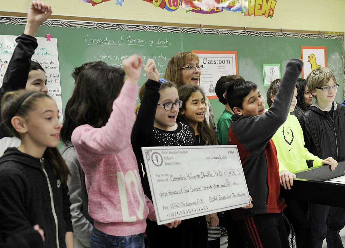 File photo from Bethel Education Foundation’s presentation of grants from last year. Clementine Hollopeter, center, a Bethel Middle School teacher, celebrates with some of her students after being presented with a check $9,473.75 from the Bethel Education Foundation. The Foundation visited three schools Monday morning, Feb. 8, 2016, to deliver more than $30,000 in Grants.