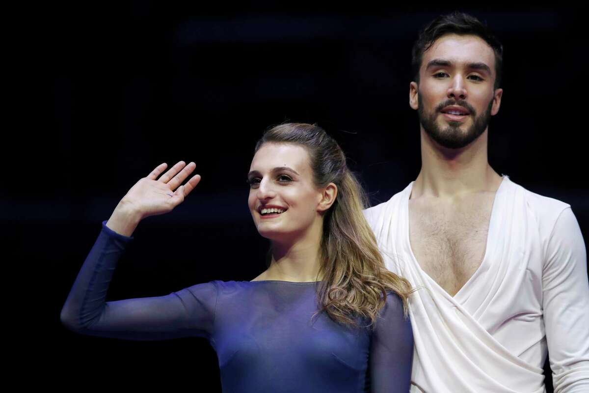 FILE - In a Saturday, Jan. 20, 2018 file photo, France's Gabriella Papadakis and Guillaume Cizeron greet spectators after winning the pairs ice dance free dance event at the European figure skating championships in Moscow, Russia. One of the oddities of figure skating is that training partners are often your biggest rivals. (AP Photo/Pavel Golovkin, File)