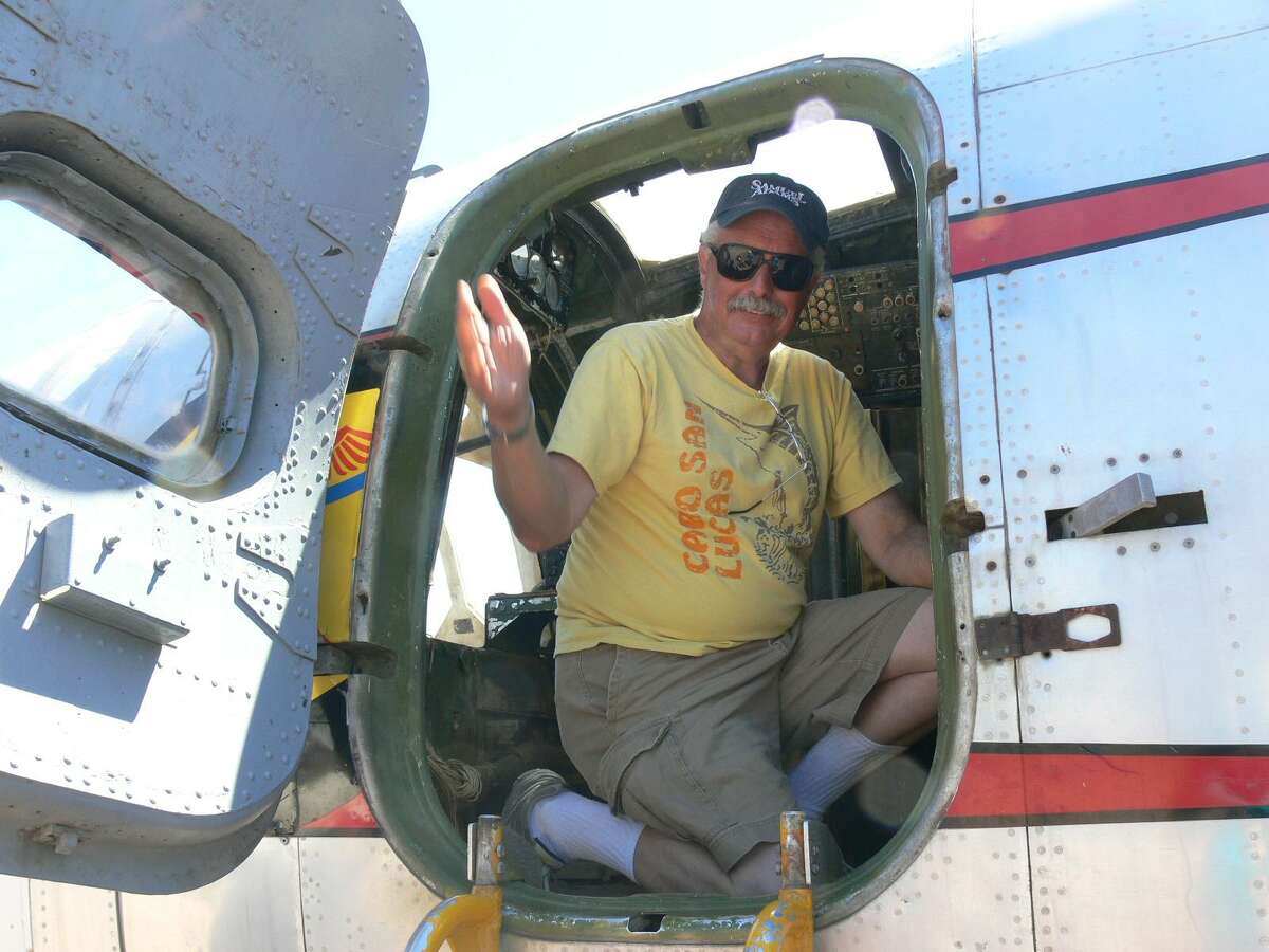 Christopher Rampoldt, who was identified as the pilot who died in a plane crash at a Concord military base, smiles and waves from a plane on the ground.