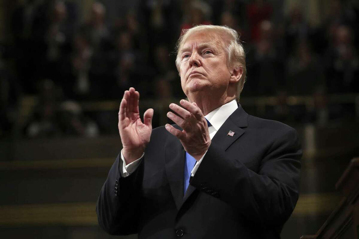 President Trump claps during his State of the Union address to a joint session of Congress in the House chamber.