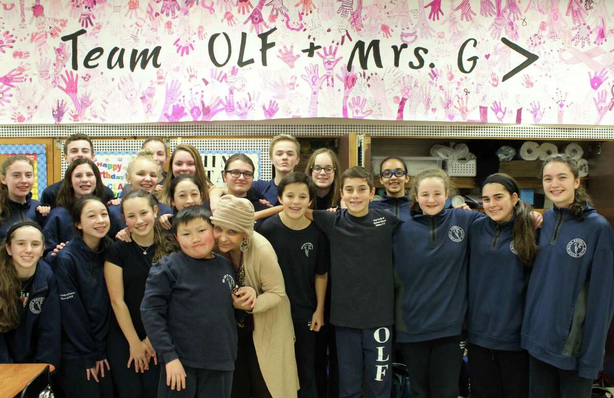 Longtime math teacher Geri Galasso with her eighth-grade homeroom class at Our Lady of Fatima School in Wilton.
