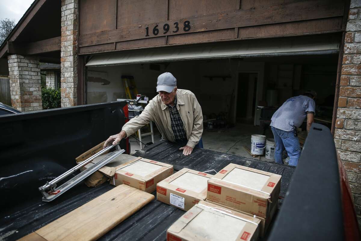 Homeowner James Unruh, left, moves material into his truck Thursday, Jan. 11, 2018 as he works to repair his home that flooded during Hurricane Harvey in Friendswood. The city of Friendswood has reverted from 2007 flood maps to 1999 maps to allow homeowners that were flooded during the hurricane to rebuild without mandating expensive home elevation requirements. ( Michael Ciaglo / Houston Chronicle)