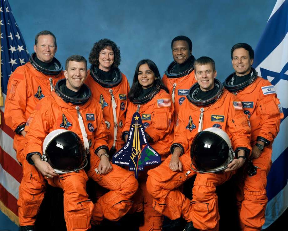 The crew of Space Shuttle Columbia's mission STS-107 take a break from their training regime to pose for the traditional crew portrait. Seated in front are astronauts Rick D. Husband (L), mission commander; Kalpana Chawla, mission specialist; and William C. McCool, pilot. Standing are (L to R) astronauts David M. Brown, Laurel B. Clark, and Michael P. Anderson, all mission specialists; and Ilan Ramon, payload specialist representing the Israeli Space Agency. The Space Shuttle Columbia broke up over Texas during re-entry on February 1, 2003. Photo: Getty Images