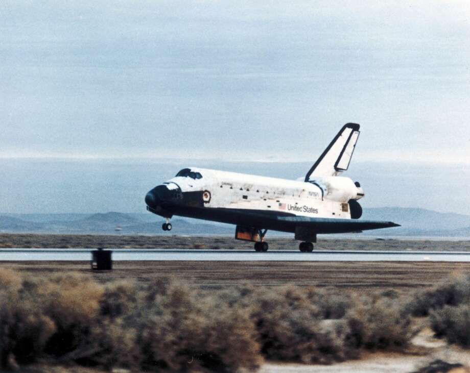 In order to descend to earth the Shuttle is turned so that its orbital manoeuvring system (OMS) engines point in the direction of travel. The engines are fired, slowing the craft until it falls to Earth. As the air gets thicker, the aerodynamic controls become effective and the Orbiter glides down to a landing. The Space Shuttle, the world's first partially reusable launch vehicle, first flew on 12th April 1981 and has been used for all America's manned space missions ever since. Columbia was the first of the Shuttle fleet to fly, and successfully completed 28 missions before being lost, together with its crew of seven, on re-entry over Texas on 1st February 2003. Photo: Science & Society Picture Library/SSPL Via Getty Images