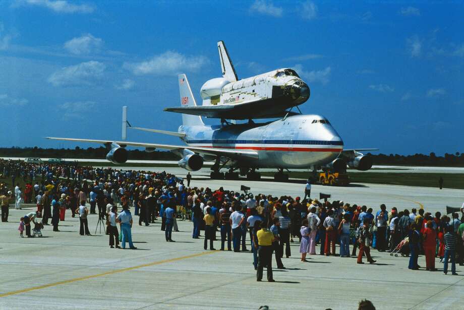 (Original Caption) Lancaster, California: The space shuttle orbiter Columbia ties up traffic as it noses into a Lancaster intersection early 3/8. The shuttle is being towed to Edwards Air Force Base where it will be placed atop a Boeing 747 for the flight to Kennedy Space Center in Florida for a scheduled 11.79 orbital launch. Photo: Bettmann/Bettmann Archive