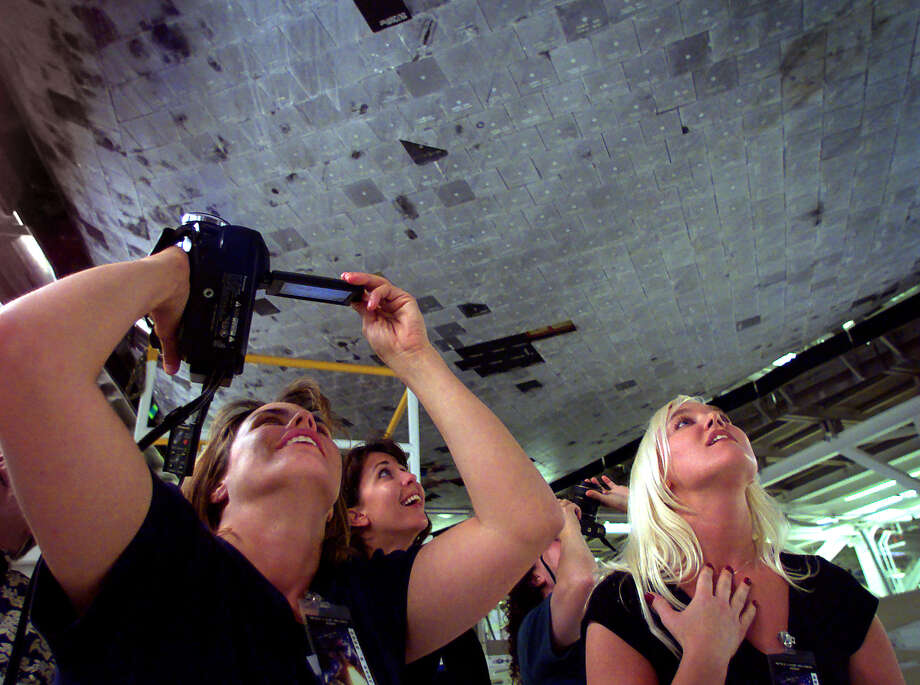 Teachers from left, Sue O'Brien(CQ), Cathie Haynes and Trina Dye marvel at the heat dissipating tiles on the underside of the space shuttle Columbia at Plant 42 in Palmdale on Thursday 8 June 2000. Du Val was among 20 public school teachers who are alumni of the annual Boeing Educators to Space Camp program visiting the Boeing Reusable Space SystemsÂ–Â–Assembly, Integration and Test Facility. Photo: Brian Vander Brug/LA Times Via Getty Images