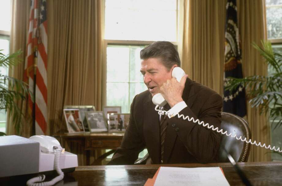 President Ronald Reagan talking on the telephone to the astronauts on space shuttle Columbia's third mission while sitting in the Oval Office of the White House. Photo: Diana Walker/Time & Life Pictures/Getty Images