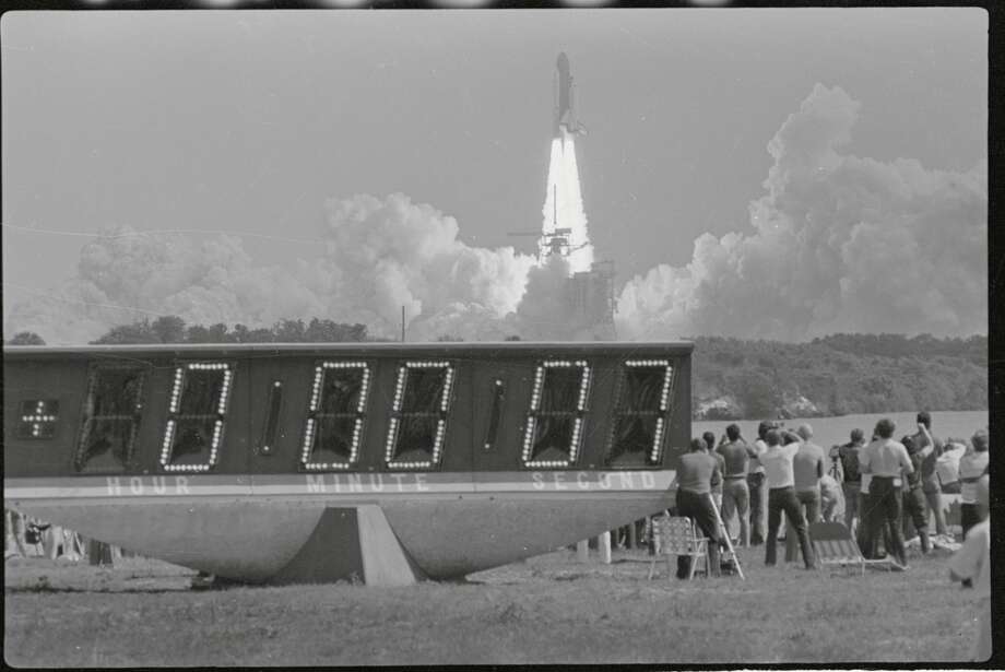 (Original Caption) Cape Canaveral: The Columbia roars away from the launch pad with news people watching. Photo: Bettmann/Bettmann Archive