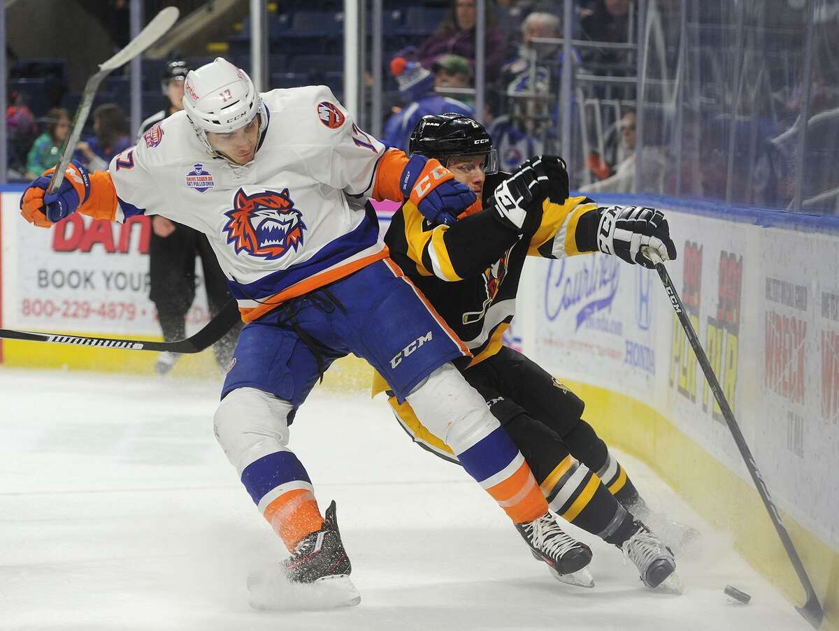 Bridgeport's Michael Dal Colle, left, checks Wilkes-Barre/Scranton's Chad Ruhwede into the boards during the opening period of their AHL hockey game at the Webster Bank Arena in Bridgeport, Conn. on Sunday, December 11, 2016.