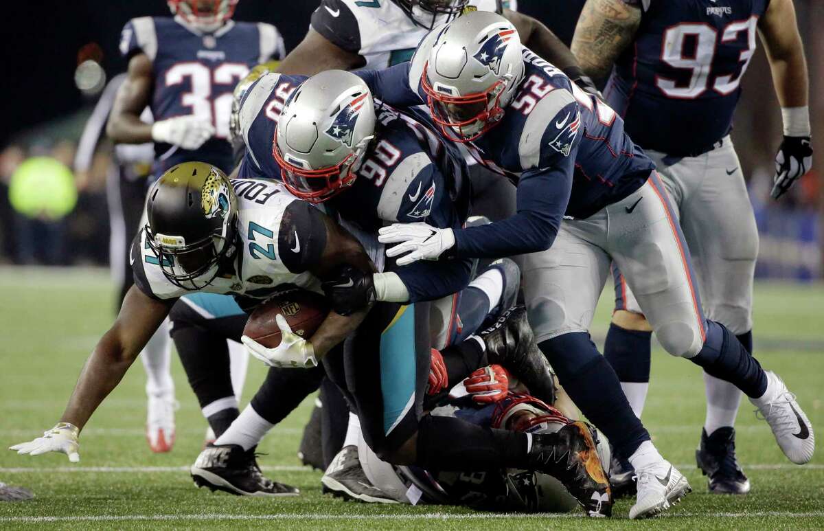 FILE- In this Sunday, Jan. 21, 2018, file photo, Jacksonville Jaguars running back Leonard Fournette (27) is tacked by New England Patriots defensive tackle Malcom Brown (90) and linebacker Elandon Roberts (52) during the second half of the AFC championship NFL football game in Foxborough, Mass. The Patriots and the Philadelphia Eagles are set to meet in Super Bowl 52 on Sunday, Feb. 4, 2018, in Minneapolis. (AP Photo/Steven Senne, File) Roberts, a former player for the Cougars, will look to add Super Bowl rings with the Patriots on Sunday.