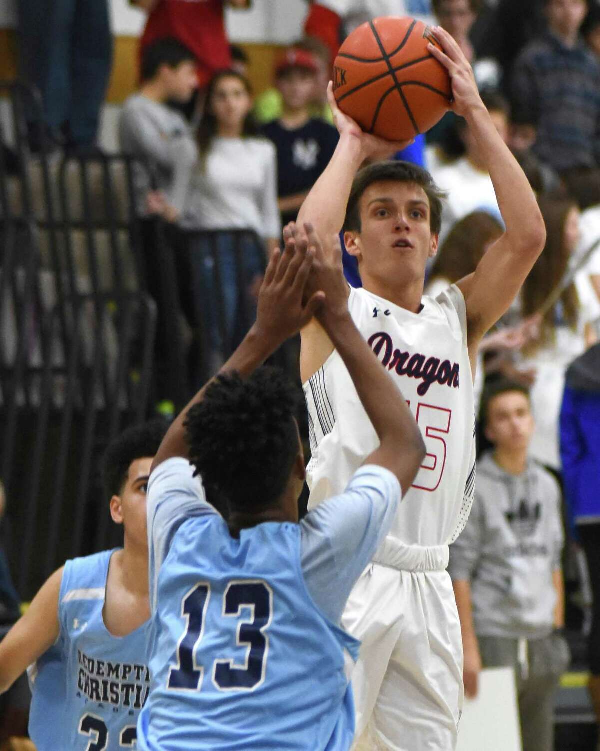 Greens Farms Academy's Henry Holzinger hoists up one of his school-record nine 3-pointers during the win over Redemption Christian Academy last Friday night.
