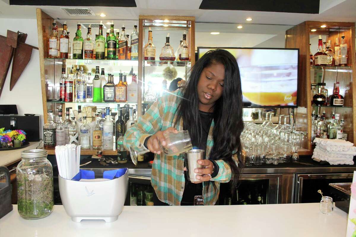 Melissa Gorman, pours a drink in the restaurant bar she co-owns, 190 Main, which opened in Westport in December.