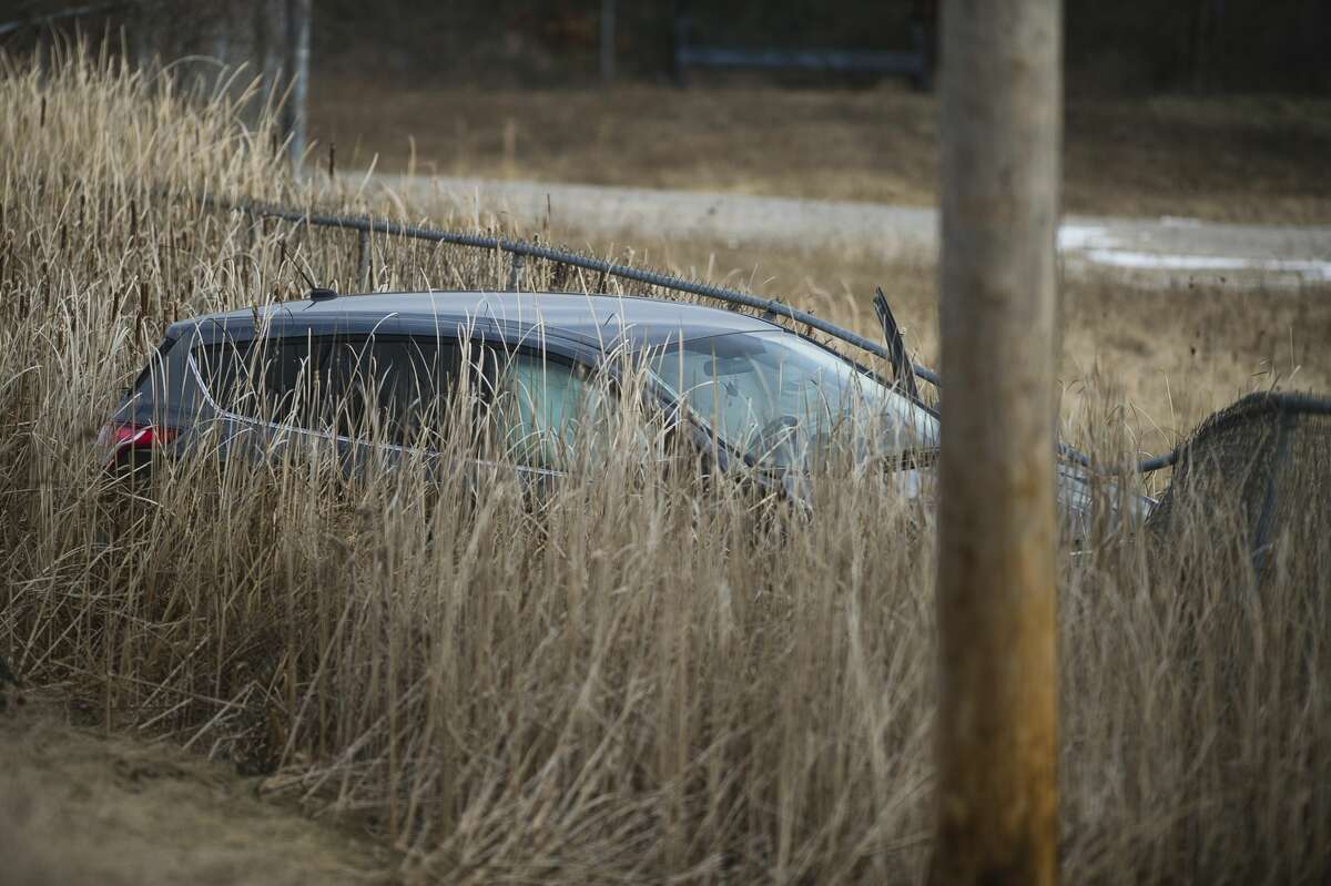 A vehicle rests in a ditch after it was involved in a collision on M-20 near Westlawn Drive on Thursday, Feb. 1, 2018. (Katy Kildee/kkildee@mdn.net)
