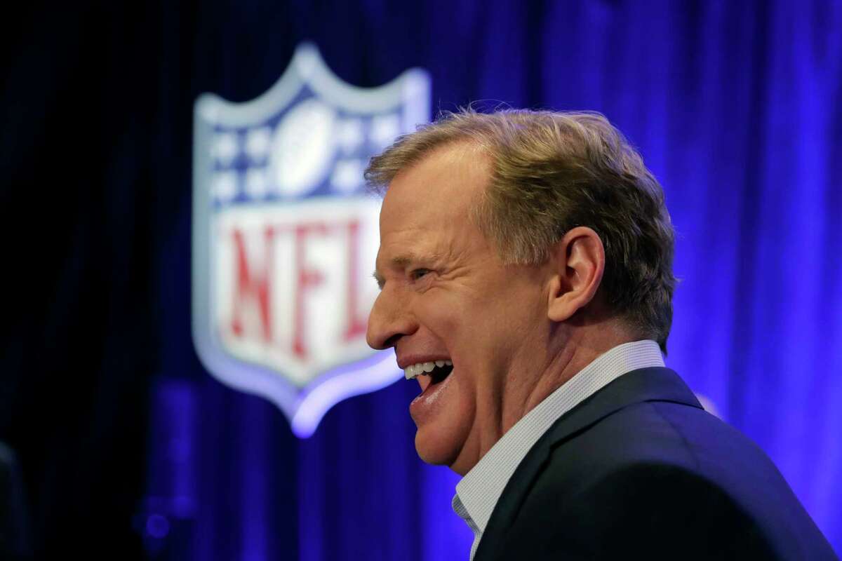 NFL Commissioner Roger Goodell laughs after talking with former head coach Tony Dungy before a news conference in advance of the Super Bowl 52 football game, Wednesday, Jan. 31, 2018, in Minneapolis. The Philadelphia Eagles play the New England Patriots on Sunday, Feb. 4, 2018. (AP Photo/Matt Slocum)