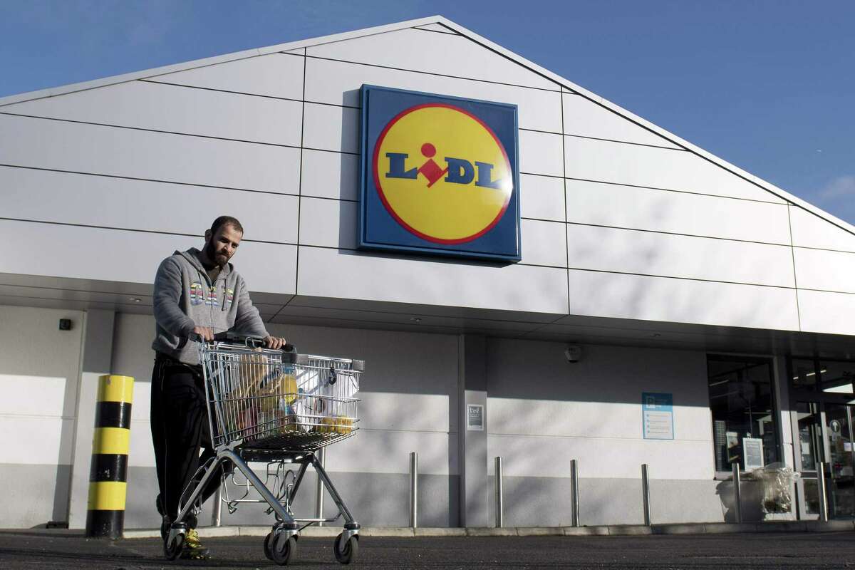 A man leaves with his goods after shopping at a branch of Lidl supermarket in south London, on January 10, 2018. Traditional supermarket chains, such as Tesco, Sainsbury's and Morrisons, benefited by between 2% and 3% sales growth in value, but to a much lesser degree than German discount companies Aldi and Lidl (up 16.8 % each) who are taking a larger and larger share of the cake. / AFP PHOTO / Justin TALLISJUSTIN TALLIS/AFP/Getty Images