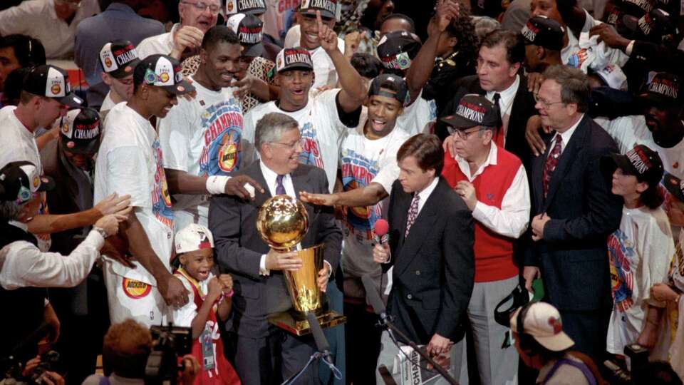 06/22/1994 - NBA Commissioner David Stern presents the NBA Championship Trophy to the Houston Rockets team after they defeated the New York Knicks in the 7th and final game, June 22, 1994. © Houston Chronicle