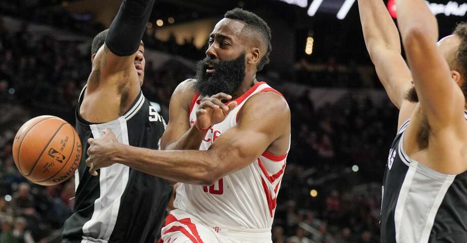 Houston Rockets' James Harden, center, passes the ball as he is guarded by San Antonio Spurs' LaMarcus Aldridge, left, and Kyle Anderson during the first half of an NBA basketball game Thursday, Feb. 1, 2018, in San Antonio. (AP Photo/Darren Abate) Photo: Darren Abate/Associated Press