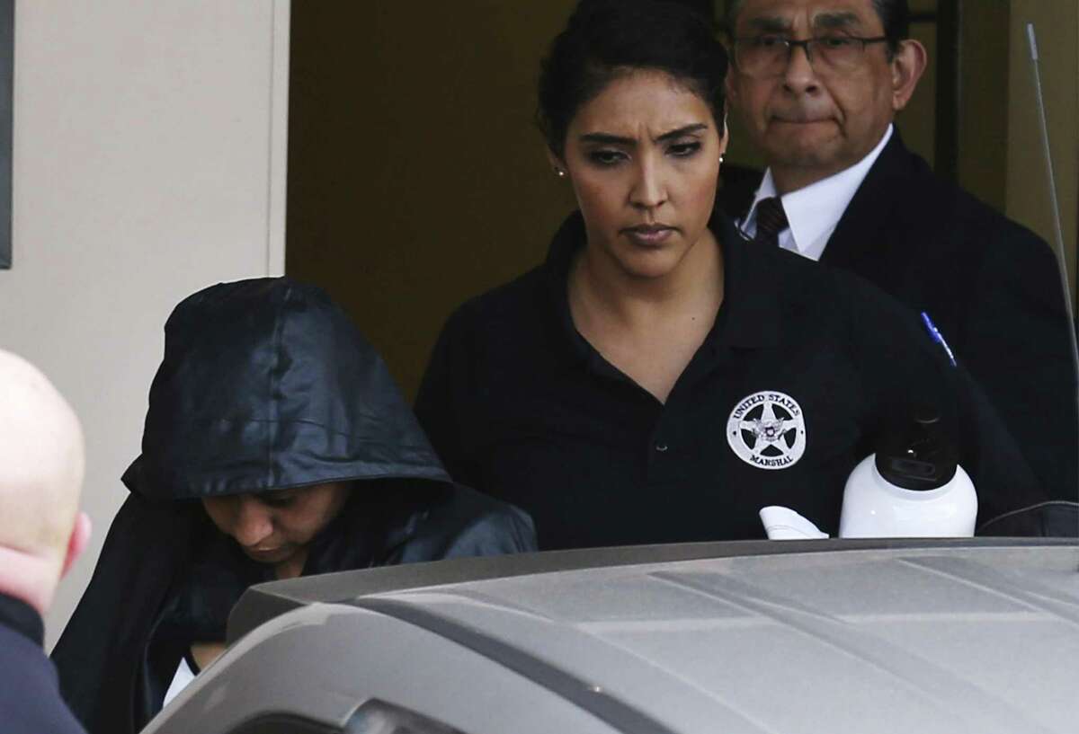 Hidden under security and a jacket, Denise Cantu (left), the Harlingen woman who prosecutors allege Carlos Uresti carried on a sexual relationship with and then exploited by convincing her to invest in a startup oil field company, has taken the witness stand in the state senators criminal fraud trial on Thursday, Feb. 1, 2018. (Kin Man Hui/San Antonio Express-News)