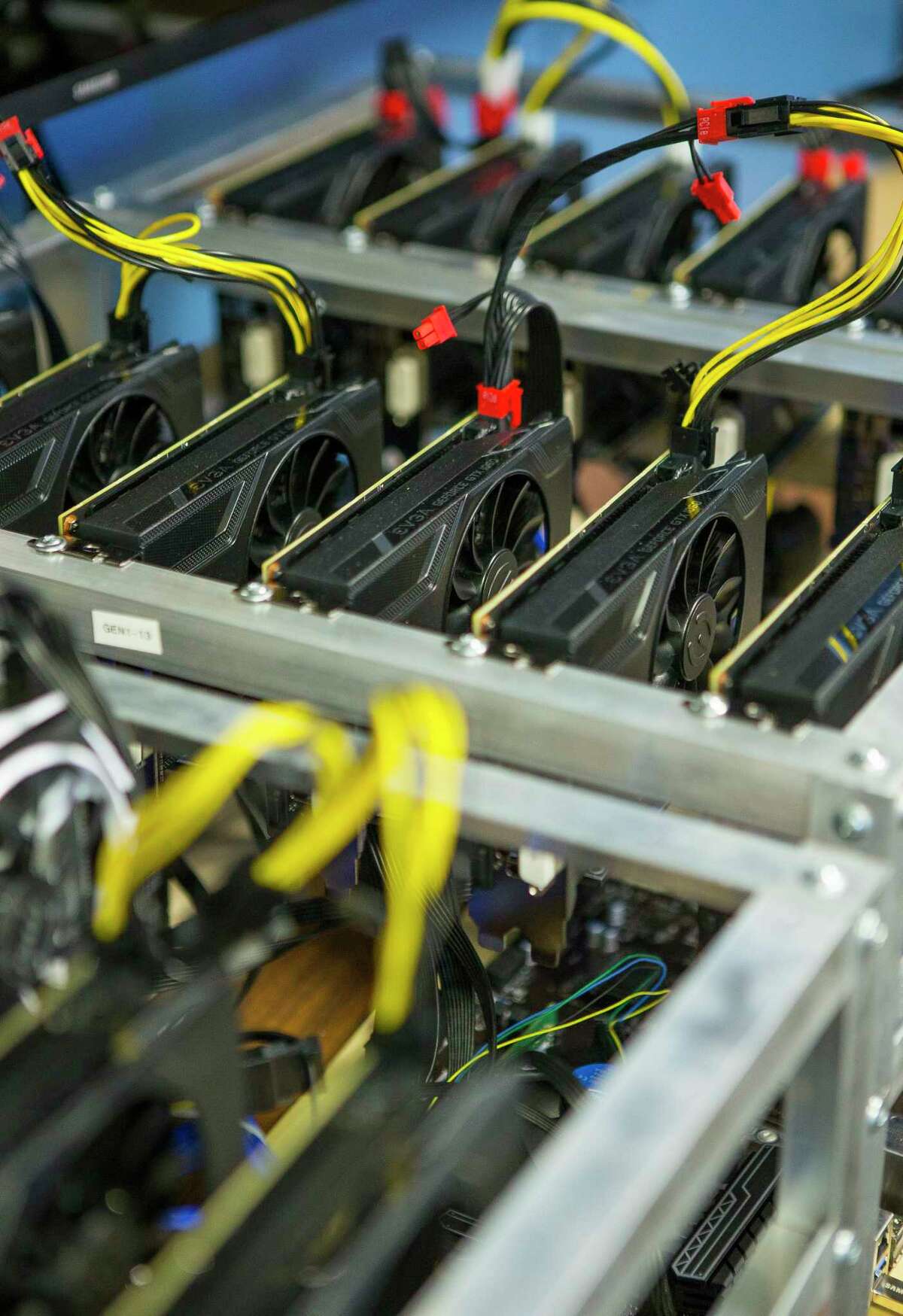 Arrays of video cards sit in cryptocurrency mining rig inside the Snapstream offices, Wednesday, Jan. 24, 2018, in Houston. CEO Rakesh Agrawal's company is building cryptocurrency mining rigs that use high powered video cards as their base.