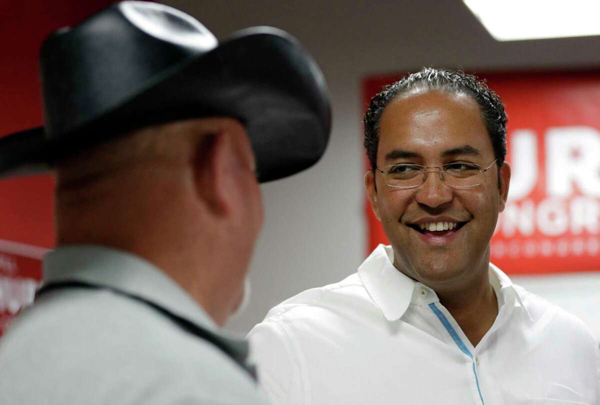 In this Aug. 27, 2016, file photo, first-term Republican Rep. Will Hurd, right, of Texas, talks with a supporter at a campaign office in San Antonio. In the 2018 elections, Hurd will face the winner of a May 22 Democratic primary runoff. (AP Photo/Eric Gay, File)