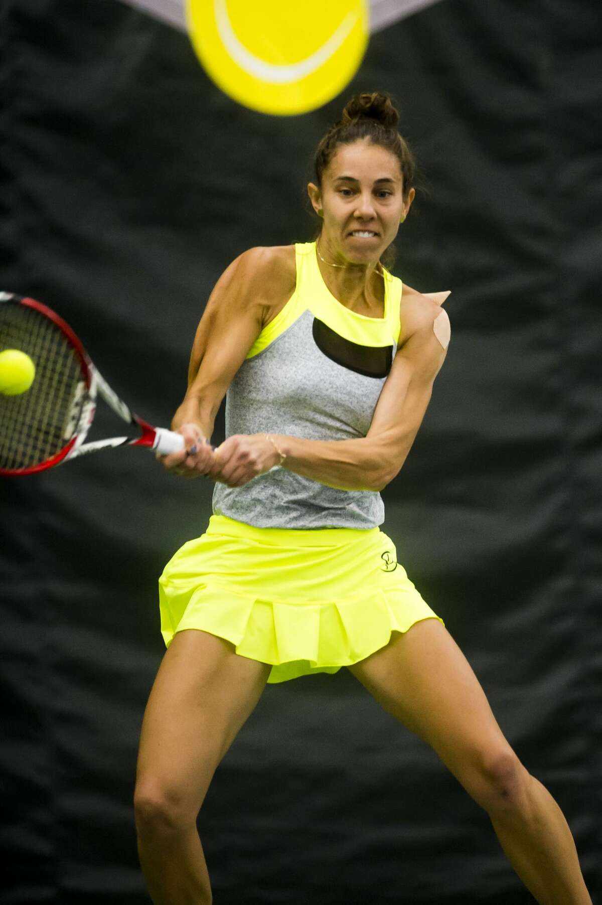 Mihaela Buzarnescu of Romania returns the ball in a match against Rebecca Peterson of Sweden during the Dow Tennis Classic on Friday, Feb. 2, 2018 at the Greater Midland Tennis Center. (Katy Kildee/kkildee@mdn.net)