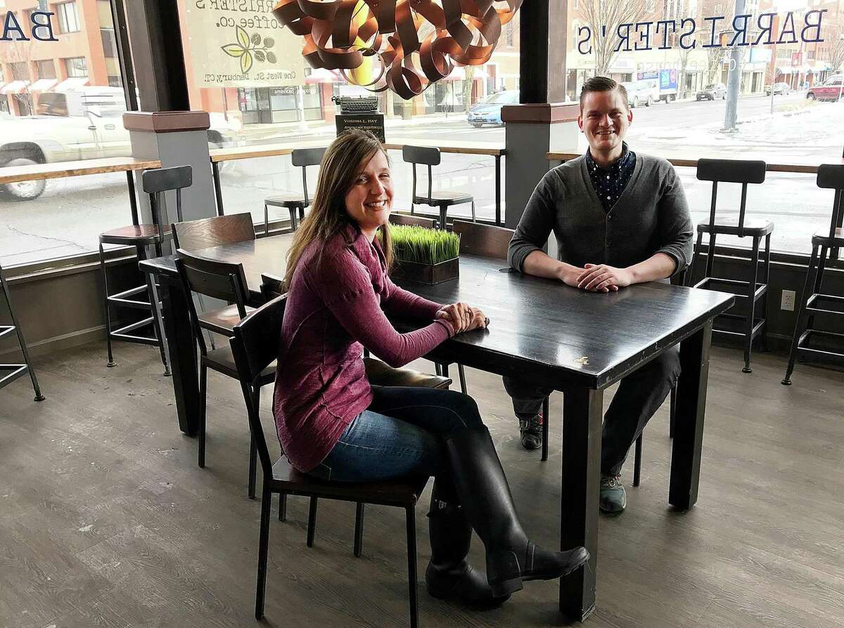 Barrister's Coffee House owner Tracy Hoekenga and manager Jordan Jones sit at one of the tables in the new coffee shop in Danbury, Conn., on Friday, Feb. 2, 2018.