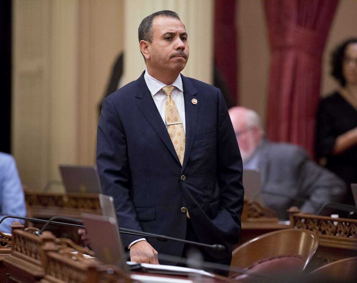 File - In this Jan. 3, 2018 file photo, Sen. Tony Mendoza, D-Artesia, stands at his desk after announcing that he will take a month-long leave of absence while an investigation into sexual misconduct allegations against him are completed during the opening day of the Senate in Sacramento, Calif. Documents released Friday, Feb. 2, 2018, by the California Legislature show four current lawmakers faced sexual misconduct complaints since 2006. The documents outline complaints against Democratic Assemblywoman Autumn Burke of Los Angeles, Republican Assemblyman Travis Allen of Huntington Beach, Democratic Sen. Tony Mendoza of Artesia and Democratic Sen. Bob Hertzberg of Van Nuys. (AP Photo/Steve Yeater, File)