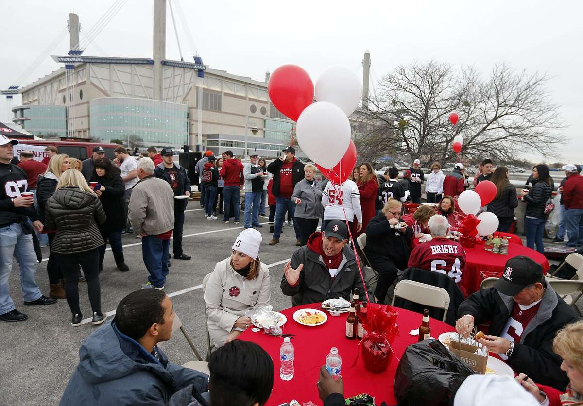 Stanford University fans Carey and Jeff Riccitelli (center left), parents of Stanford place kicker Collin Riccitelli (37) and others tailgate before the Alamo Bowl held Dec. 28, 2017, at the Alamodome.
