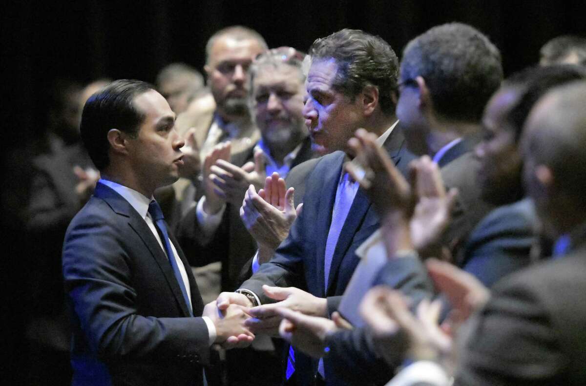 HUD Secretary Julian Castro (left) is greeted by New York Gov. Andrew Cuomo and a standing ovation after addressing the Governor’s Regional Conference on Sustainable Community Development in this 2016 photo. He plans to decide whether to enter the quest for the 2020 nomination by the end of the year.