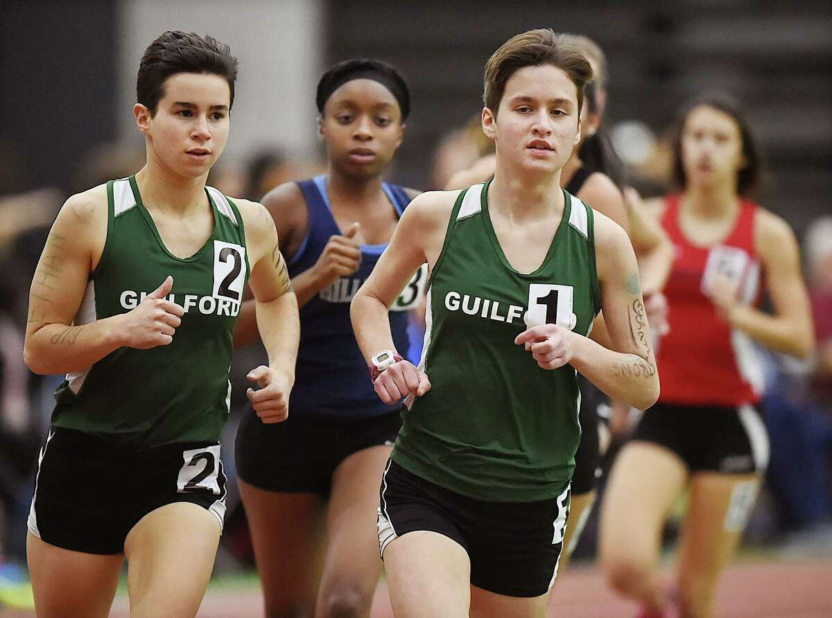 Guilford's Meredith Bloss, (wearing #1) wins the 1600 meter run in 5:32.41 and senior Jacqueline Guerra (#2) placed second in 5:35.72 at the SCC track and field championships, Feb. 2, 2018, at Floyd Little Athletic Center in New Haven. Bloss, a junior won the 3200 meter run in 12:00.66 and Guerra finished second in 12:04.12.