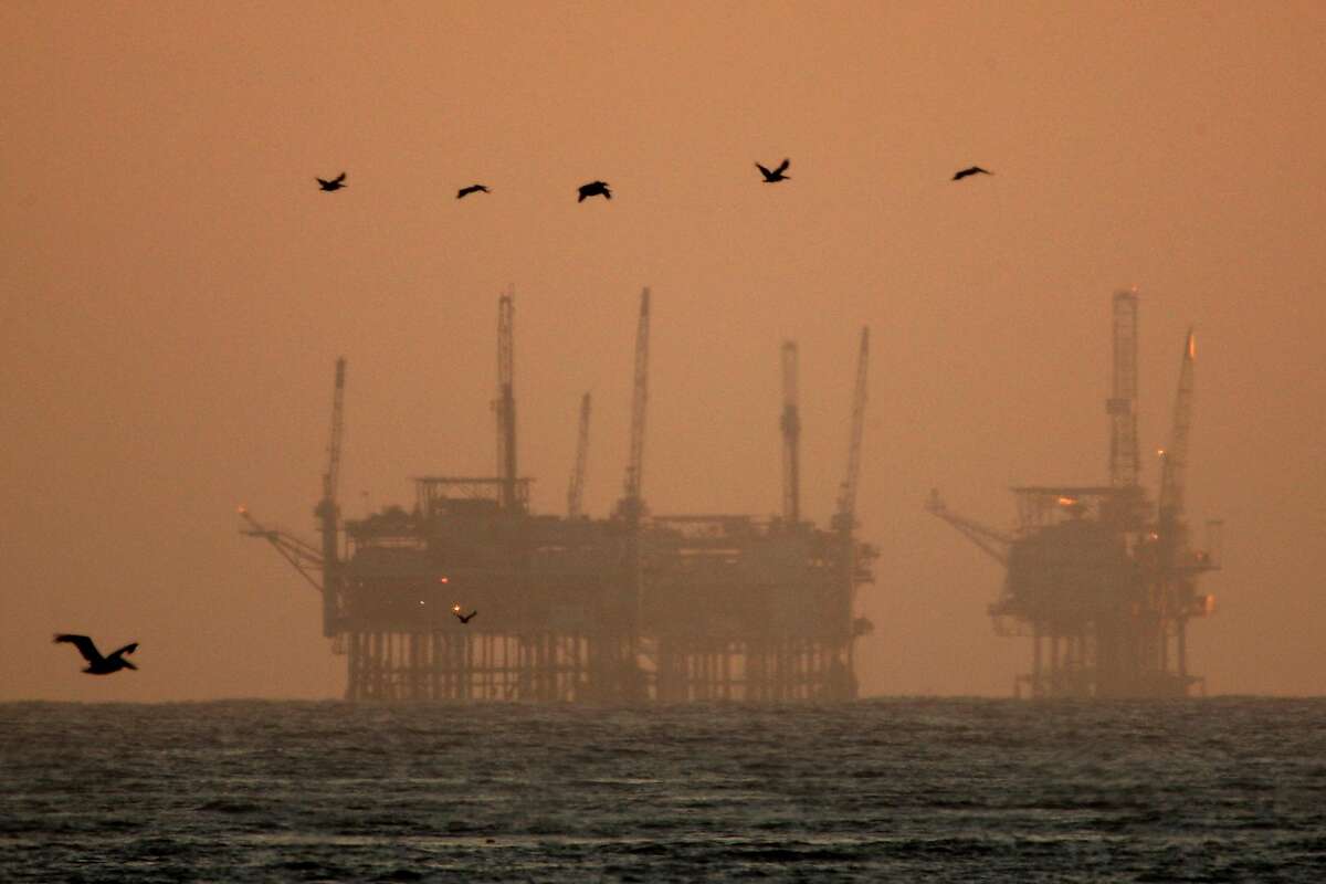 California brown pelicans fly near offshore oil rigs after sunset on July 21, 2009 near Santa Barbara, California. After months of partisan bickering over how to close the $ 26.3 billion deficit and begin paying the state's bills again, California Gov. Arnold Schwarzenegger and legislative leaders reached a tentative budget deal this week to keep one of the world's largest economies from falling into insolvency. Within the budget agreement, Gov. Schwarzenegger succeeded in having a proposal to expand oil drilling off the Southern California coast for the first time in more than 40 years. In 1969, the Santa Barbara Oil Spill from Union Oil Co. undersea drilling platform caused 200,000 gallons of crude oil to spread over 800 square miles of ocean and beaches and created a massive public outcry against drilling off the state's coast. During the 2008 presidential election, Republicans and Conservatives began pushing for renewed offshore drilling. The budget plan contains massive cuts in state spending and social services. Lawmakers can vote on the deal as soon as this week even as cities and conservation groups gear up to sue the governor and Legislature over emerging details that they disapprove of. (Photo by David McNew/Getty Images)