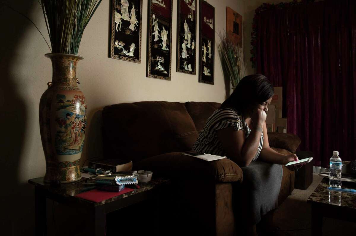 Shanda Carter, 51, reads the update of the lawsuit of her husband of three years, Michael Carter, 39, in her apartment on Friday, Feb. 2, 2018, in Seabrook. Michael is a heat-sensitive inmate with diabetes who was assigned to the Pack Unit in Navasota, northwest of Houston. He could live on a unit with air conditioning after a federal judge in Houston approved a deal between the prison and the inmates who sued.