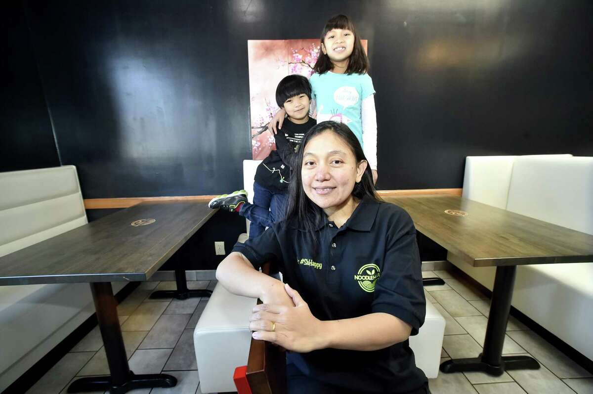 Soraya Kaoroptham, owner of Noodle House on the Boston Post Road in Orange, with her son, A.J. Kaoroptham, 5, and daughter, Anaya Kaoroptham, 8, at the restaurant.