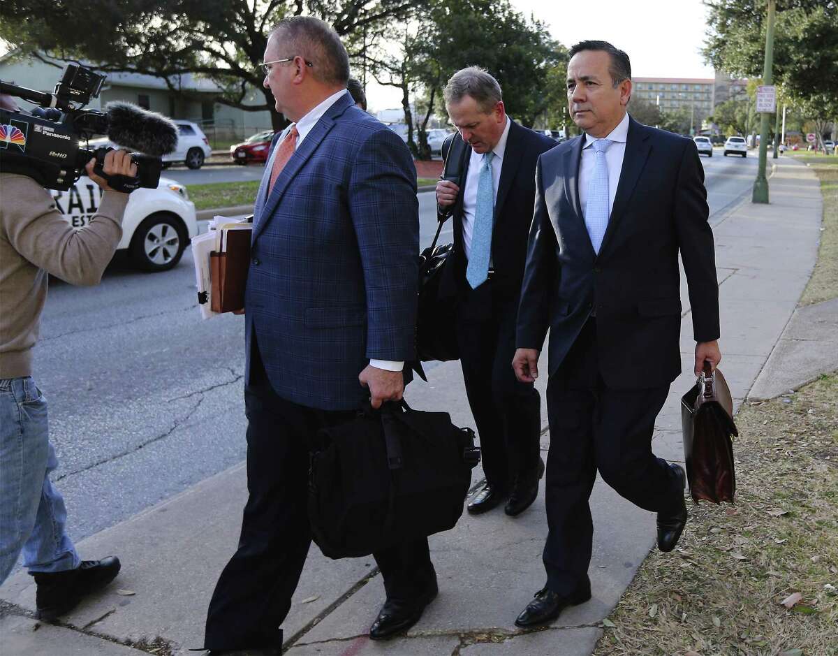 State Sen. Carlos Uresti (right) leaves with his attorneys from the John Wood Federal Courthouse after another day of testimony surrounding his indictment last year on 11 felony charges, including conspiracy to commit wire fraud, securities fraud and money laundering, in connection with his role at FourWinds Logistics. (Kin Man Hui/San Antonio Express-News)