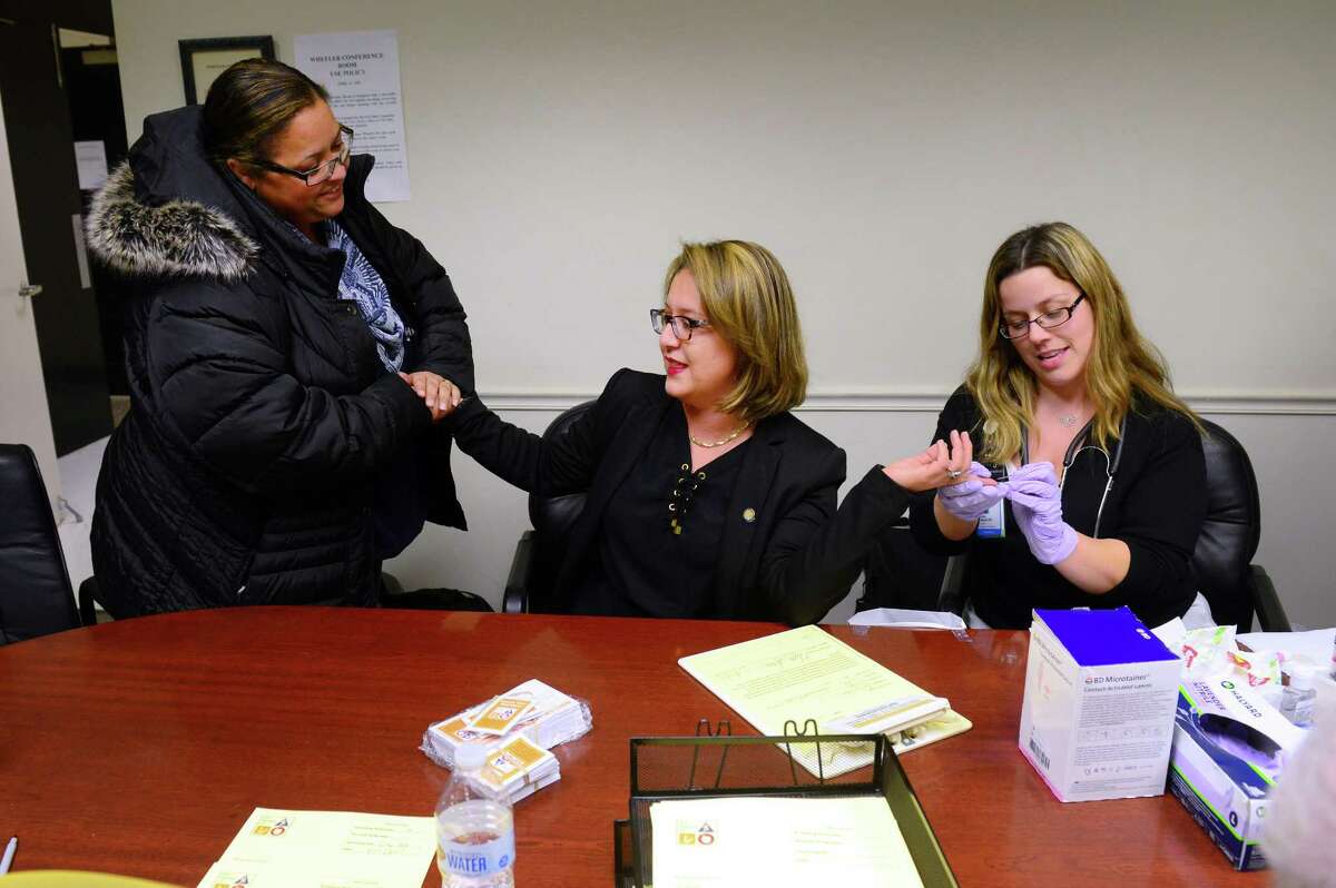 Bridgeport City Councilwoman Milta Feliciano, center, is comforted by city employee Albertina Baptista, left, as Nicole Rogucki, R.N. takes a sample of blood during the Know Your Numbers health screening event at City in Bridgeport, Conn., on Tueday Jan. 17, 2017. The Bridgeport Department of Health and Social Services will co-host a screening 5:30 to 7:30 p.m. on Monday, Feb. 5, 2018, before the regularly scheduled Bridgeport City Council meeting at Bridgeport City Hall, 45 Lyon Terrace, as part of this year’s Know Your Numbers campaign for heart month, which is February.