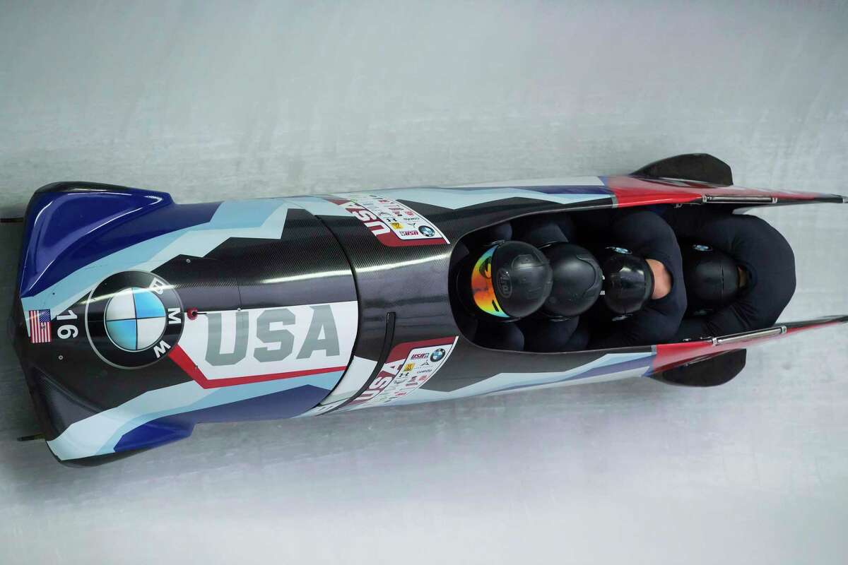 In this Nov. 25, 2017, file photo, Codie Bascue, Nathan Weber, Carlo Valdes and Samuel McGuffie, of the United States, compete in a four-man World Cup bobsled race in Whistler, British Columbia. McGuffie has scored at Notre Dame Stadium. Little did he know he was on a path to the Olympics. McGuffie was a running back at Michigan and Rice, bounced around some NFL and CFL clubs, then got told about bobsledding. Not long afterward, he met Steven Holcomb, and this season, McGuffie's first Olympic season, has been a tribute to his late friend. In this Nov. 25, 2017, file photo, Codie Bascue, Nathan Weber, Carlo Valdes and Samuel McGuffie, of the United States, compete in a four-man World Cup bobsled race in Whistler, British Columbia. McGuffie has scored at Notre Dame Stadium. Little did he know he was on a path to the Olympics. McGuffie was a running back at Michigan and Rice, bounced around some NFL and CFL clubs, then got told about bobsledding. Not long afterward, he met Steven Holcomb, and this season, McGuffie's first Olympic season, has been a tribute to his late friend.