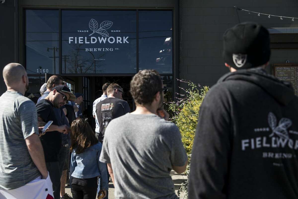 Dozens line up outside Fieldwork Brewing Company for a chance to take home three specialty beers during a special can release Saturday, Feb. 3, 2018 in Berkeley, Calif.