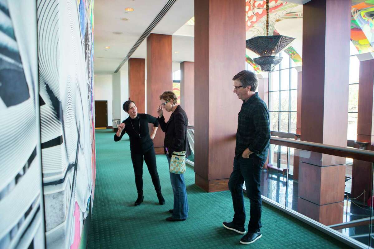 Susana Monteverde, Francesca Fuchs and Tommy Fitzpatrick take a look at Frank Stella's monumental public artwork "Euphonia" on the walls and ceiling of the Moores Opera House which they helped to paint in 1997. Wednesday, Jan. 31, 2018, in Houston. ( Marie D. De Jesus / Houston Chronicle )