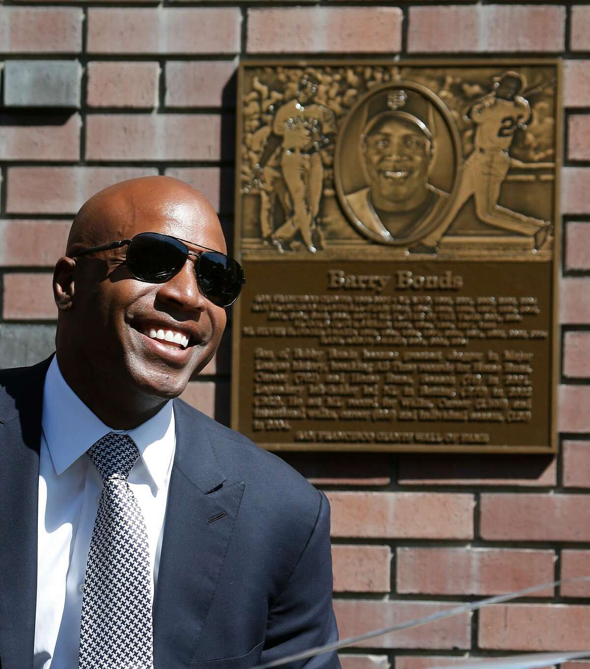 Barry Bonds smiles at fans after a plaque is unveiled during a ceremony to enshrine the retired slugger on the Giants' Wall of Fame on King Street outside of AT&T Park in San Francisco, Calif. on Saturday, July 8, 2017.