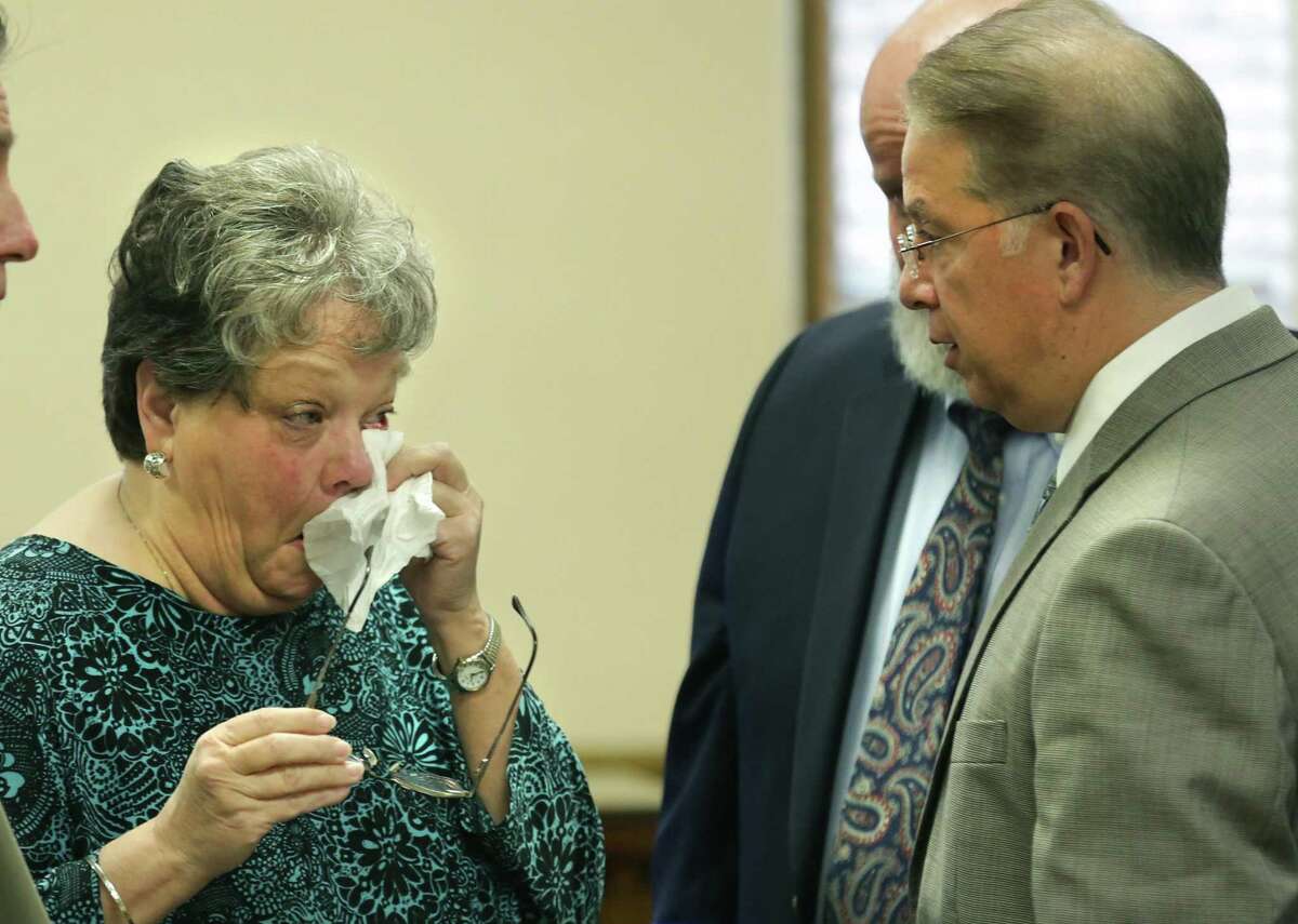 Sharlotte Mott, left, wipes away tears after testifying during the sixth day of testimony in the civil case against MPII, which does business as Mission Park Funeral Chapels and Cemeteries, accused of losing a body from a casket in 2015, in the 131st Civil District Court on Tuesday, Feb. 6, 2018.