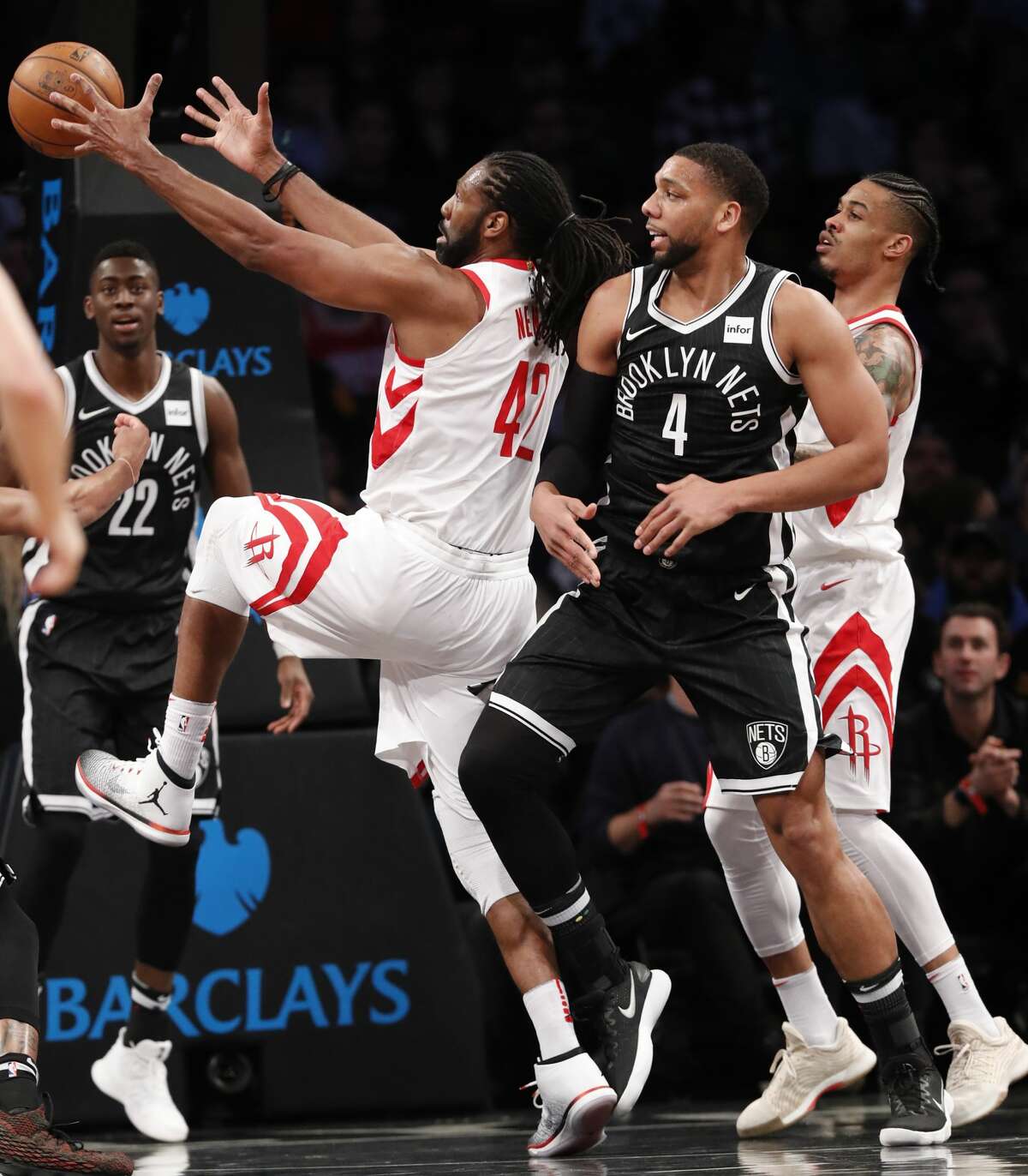 Houston Rockets center Nene Hilario (42) grabs a rebound i front of Brooklyn Nets center Jahlil Okafor (4) with Nets guard Caris LeVert (22) and the Rockets' Gerald Green, right, watching during the first half of an NBA basketball game, Tuesday, Feb. 6, 2018, in New York. (AP Photo/Kathy Willens)
