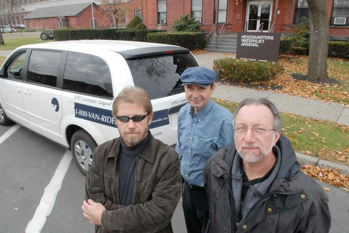 Peter Knapp, left, from Johnstown; Jan Bathurst, center, a Watervliet Arsenal employee from Fonda; and Jim Lowenthal, right, also a Arsenal employee from Gloversville, pose at the Arsenal with the van they use as part of the vanpool program at the Watervliet Arsenal. (Paul Buckowski / Times Union)