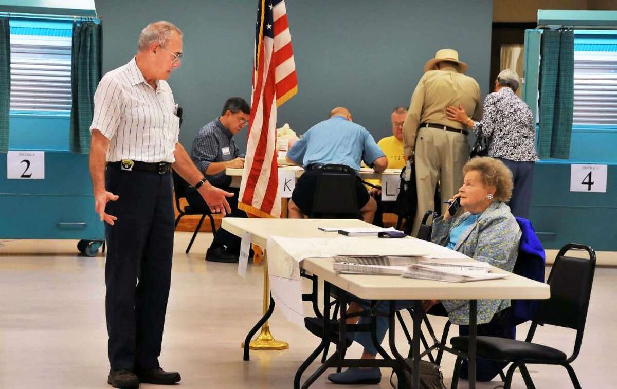 Voter Ken Sharadin, left, checks in with election inspector Jean Puckhaber at the information desk at the Milton Community Center polling place Tuesday, Sept. 15, 2009. (John Carl D'Annibale / Times Union)