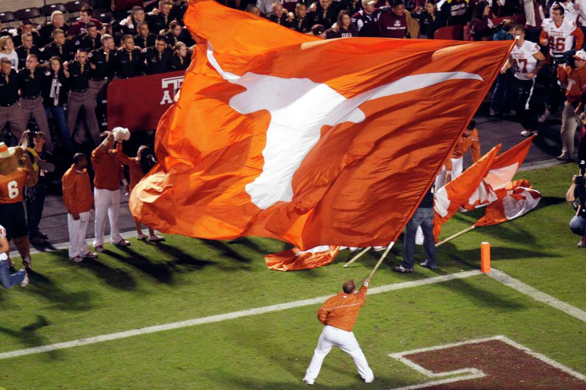 A University of Texas spirt squad member waves the Longhorns flag on Kyle Field the last time Texas and Texas A&M played each other in football.